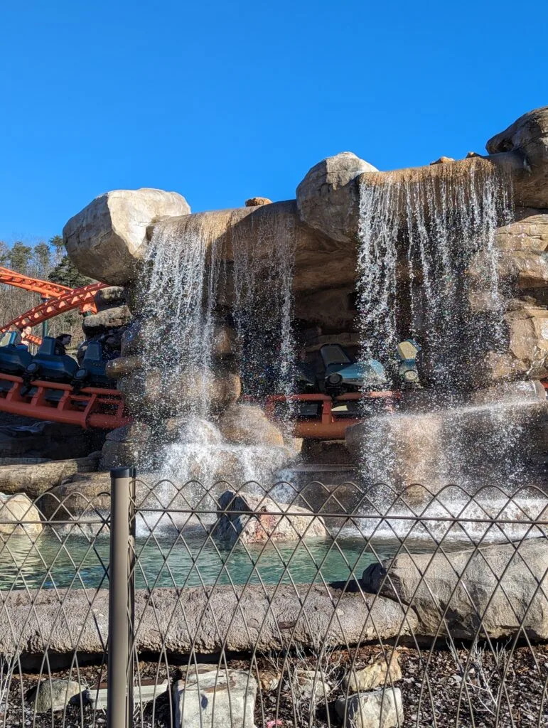 Your Ultimate Guide to Dollywood Rides: Conquer the Coasters 10 Big Bear Mountain Roller Coaster at Dollywood going under the water fall.