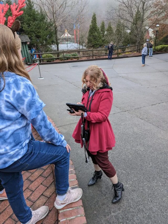 Are You Naughty or Nice? Discovering Santa's List at Dollywood 3 Elf assistant at Dollywood theme park talking to kids