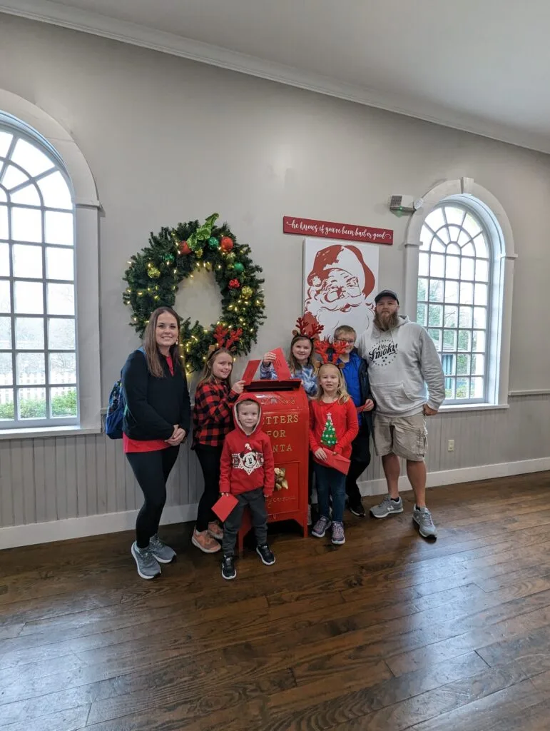 Are You Naughty or Nice? Discovering Santa's List at Dollywood 7 Family in front of Santa's Mailbox at the Santa List Experience