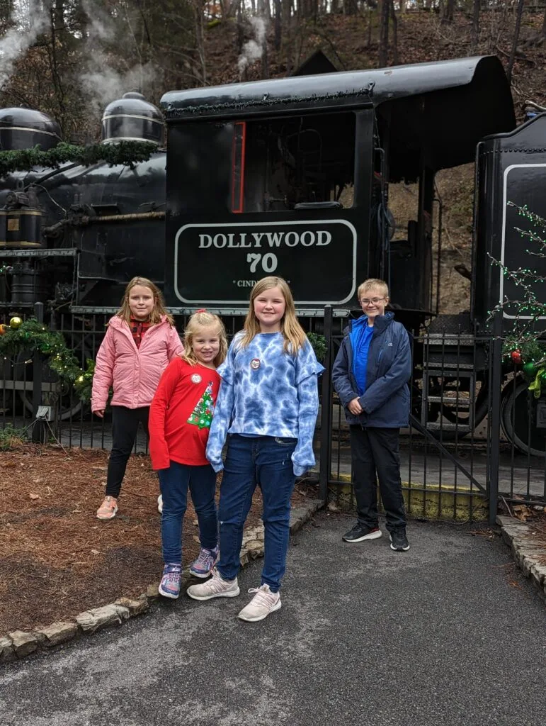 Chasing the Diamond Pass: Unraveling the Mystery of Dollywood's Elusive Top-Tier Season Pass 4 Kids in front of train at dollywood