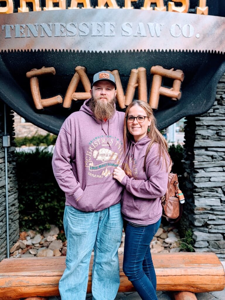 Couple in front of Crockett's Breakfast Camp Sign