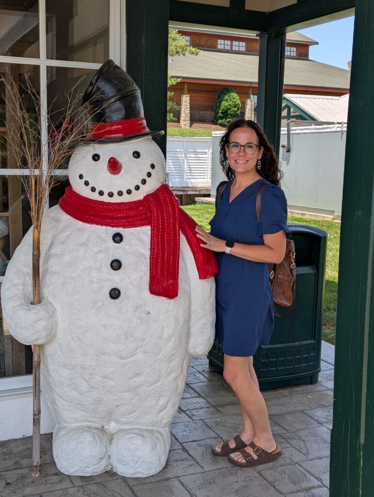 Visiting Applewood Farmhouse Grill & Shops in Sevierville, TN: A Taste of Tradition 7 Lindsay Harvey with snowman at the Candle and Christmas Shoppe in Applewood Farmhouse Village in Sevierville, TN