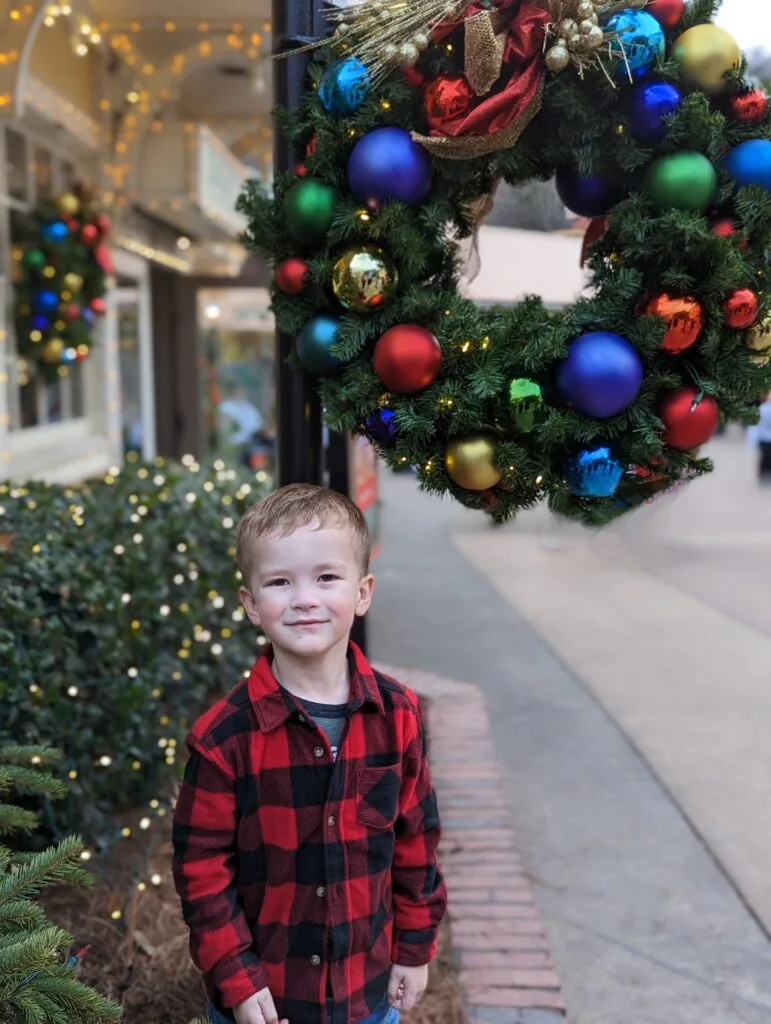 Boy in front of the Spotlight Bakery at Dollywood's Smoky Mountain Christmas Festival Photo Credit: Lindsay Harvey-Simply Touring