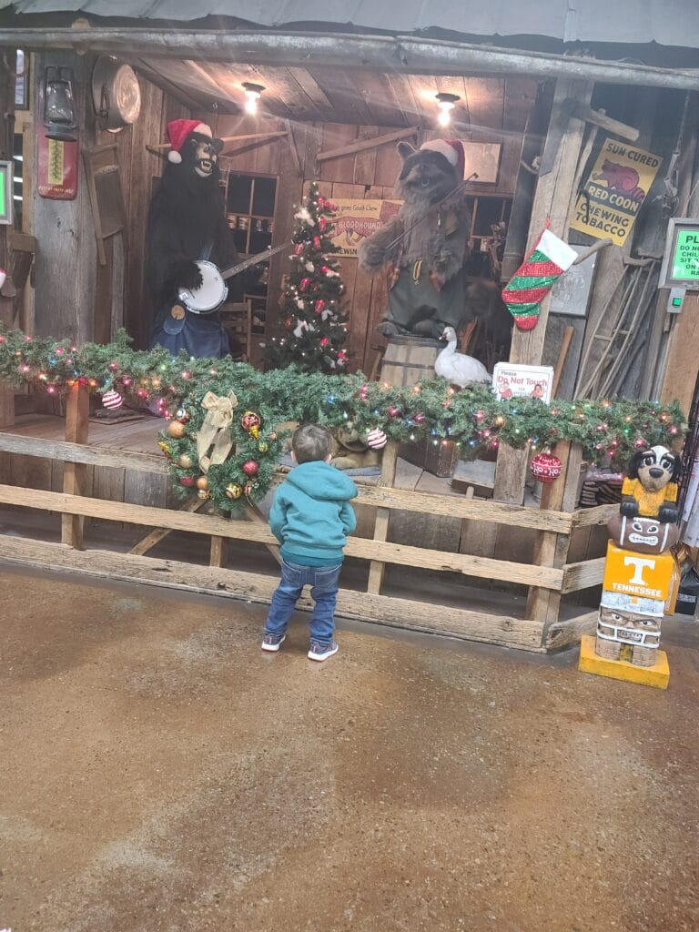 A Father's Guide to Smoky Mountain Knife Works: Where Adventure Meets Family Fun 4 Child wih Animatronic Animals at Smoky Mountain Knife Works in Sevierville, TN Photo Credit: Lindsay Harvey-Simply Touring