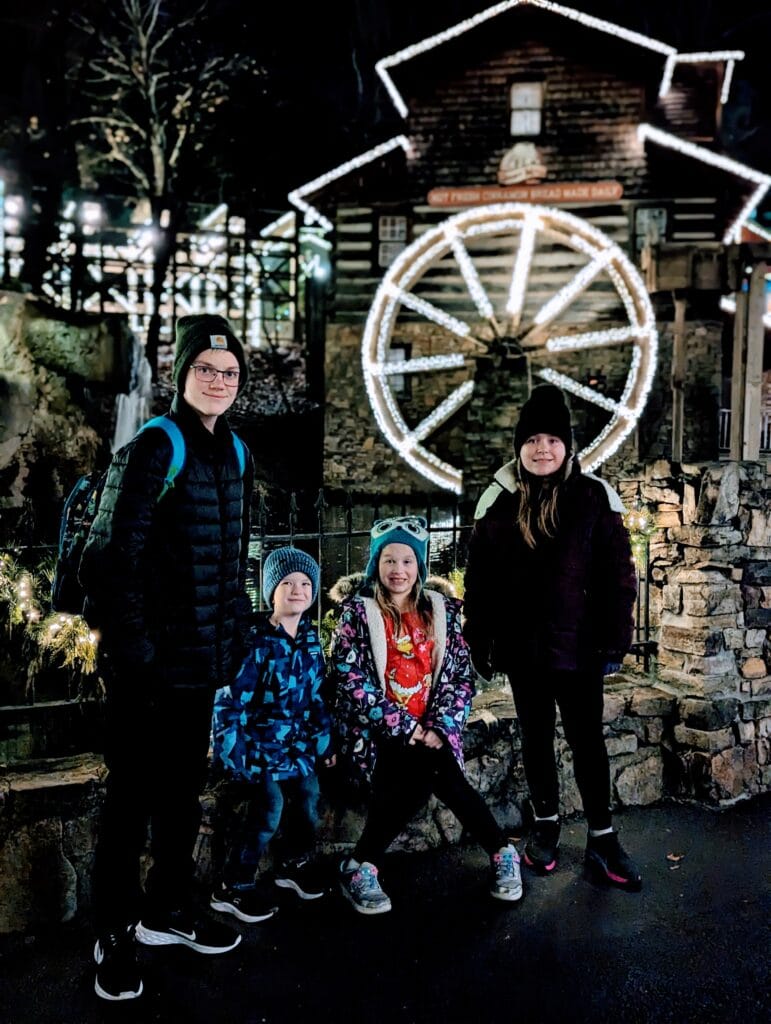 Children in front of the Grist Mill at Dollywood's Smoky Mountain Christmas Festival Photo Credit: Lindsay Harvey- Simply Touring