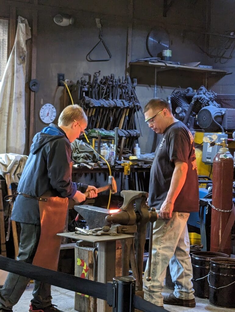 Child hammering his knife at Iron Mountain Metal Craft in Pigeon Forge, TN