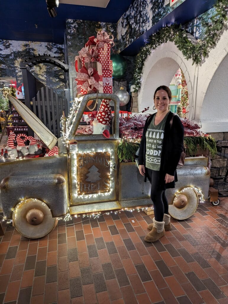 Lindsay Harvey beside truck inside The Incredible Christmas Place in Pigeon Forge, TN
