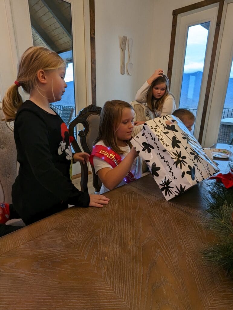 Birthdays in the Smokies: Fun Ways to Celebrate in Pigeon Forge and Gatlinburg 6 Birthday girl opening presents at Mountain Celebration Cabin in Pigeon Forge, TN